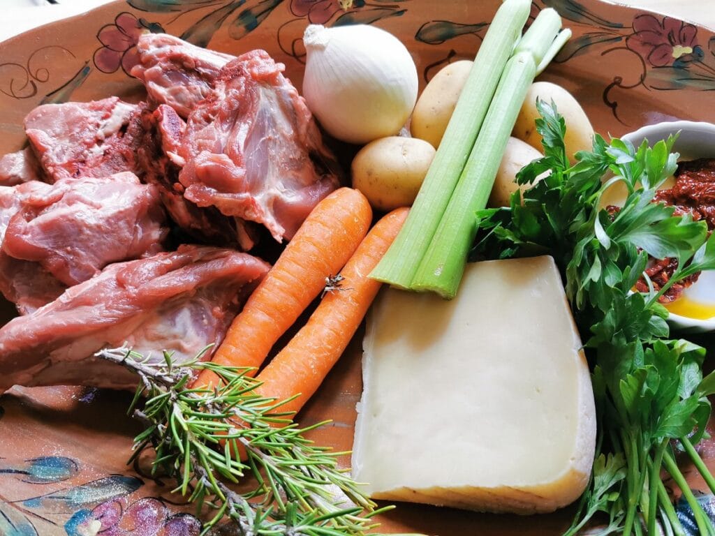 Ingredients for lamb broth on terracotta dish