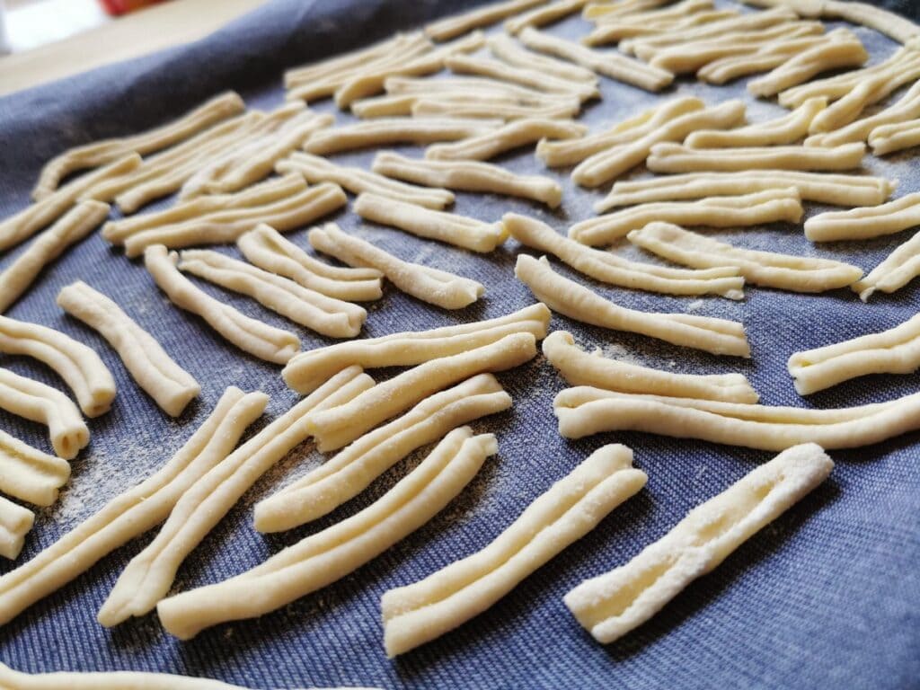 homemade casarecce made with a dough press (torchio)