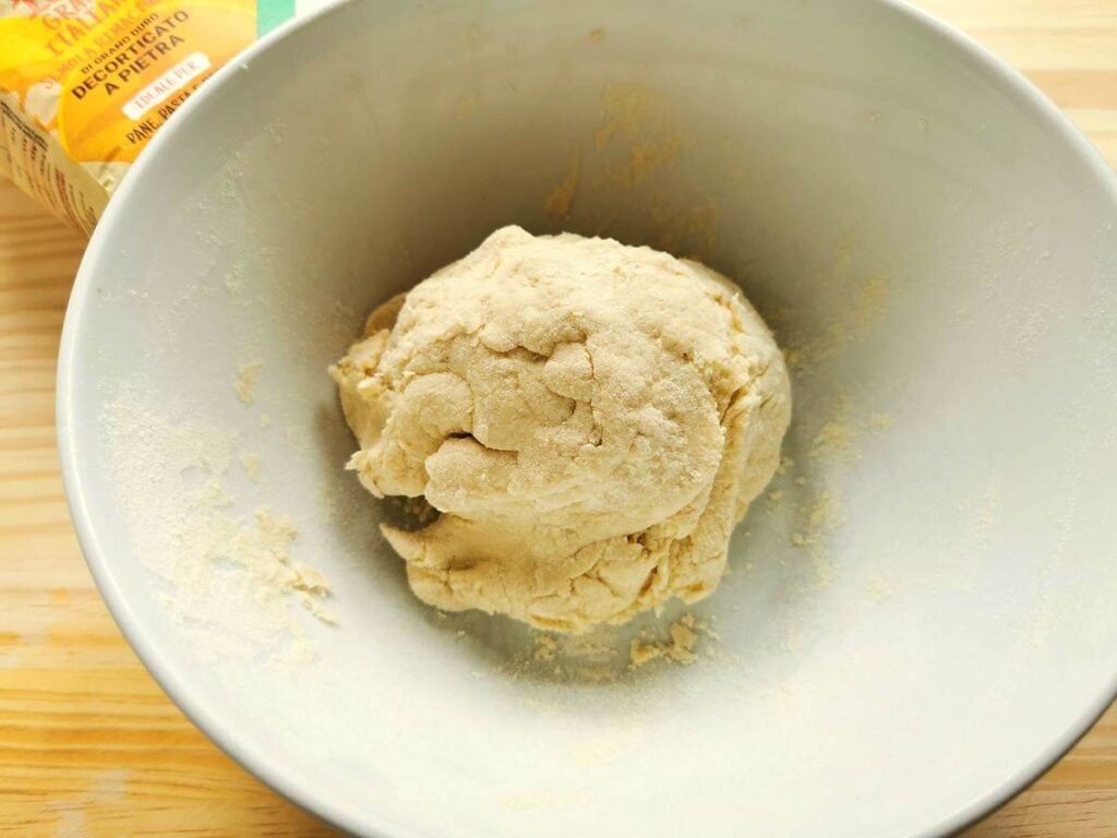 ball of pasta dough in white bowl