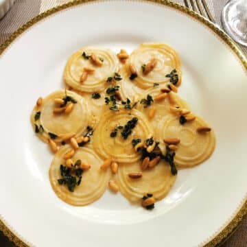 Homemade corzetti pasta with marjoram and pine nuts