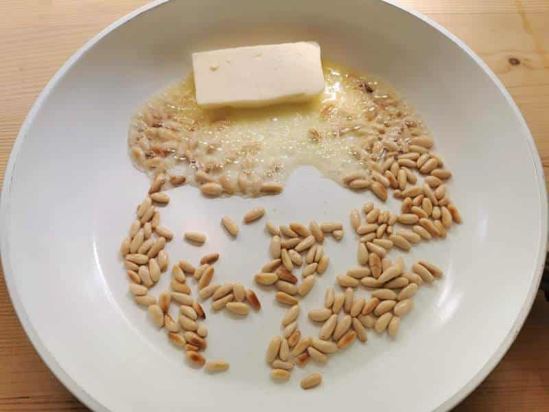 butter added to toasted pine nuts