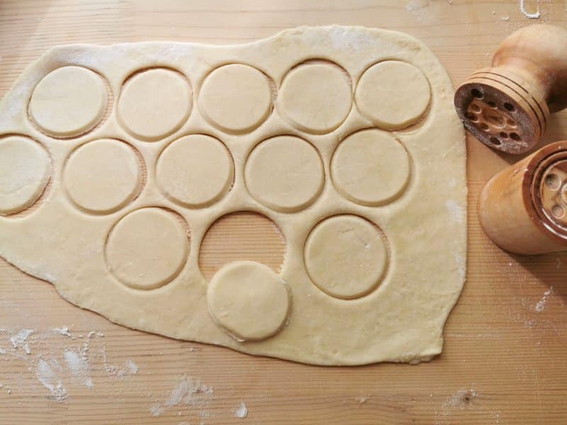 homemade corzetti pasta discs cut out of the dough.