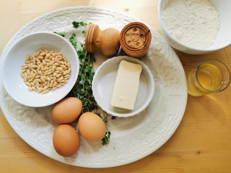 ingredients for homemade corzetti pasta with marjoram and pine nuts