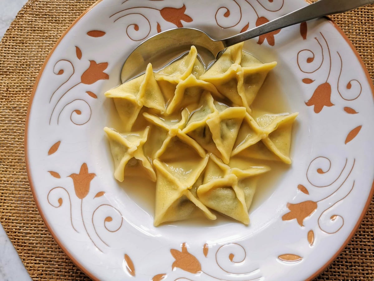 Homemade fagottini pasta served in broth.