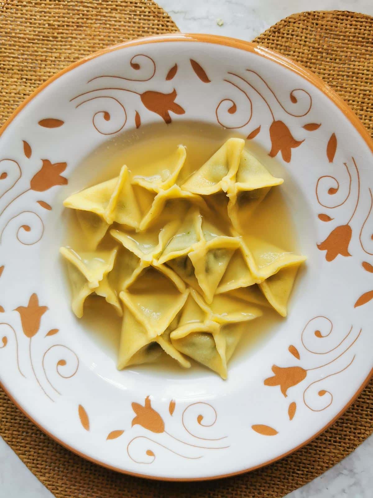 Homemade fagottini pasta in broth.