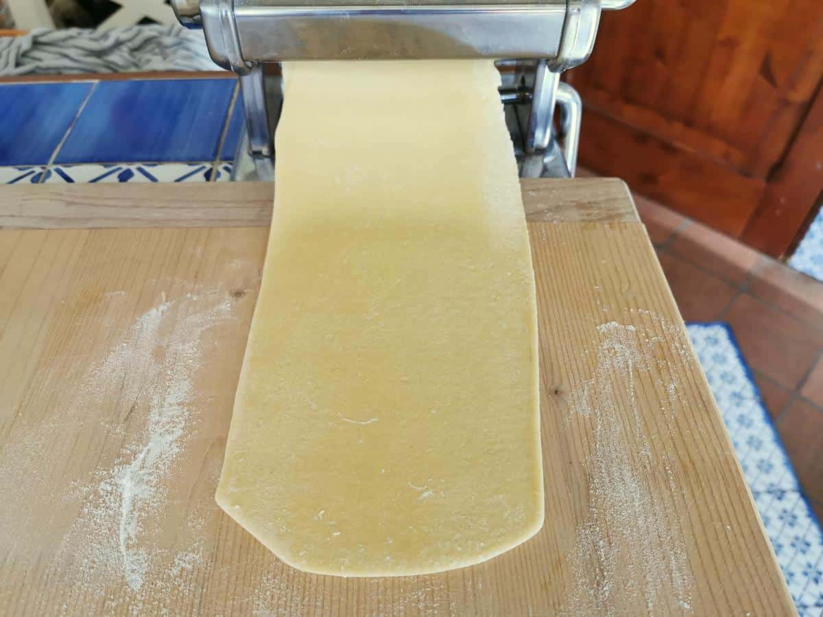 Sheet of pasta dough attached to pasta machine.