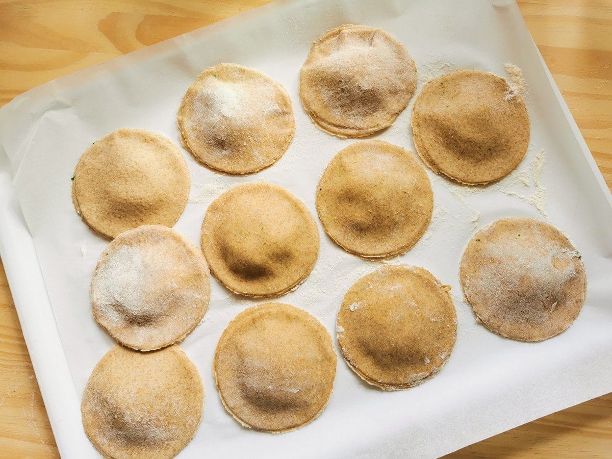 10 ready uncooked rye flour ravioli on baking papaer