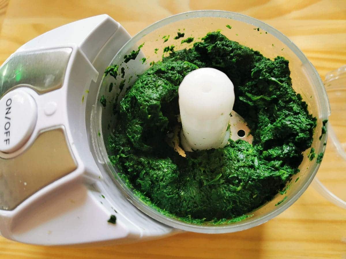 Puréed cooked spinach in food processor.