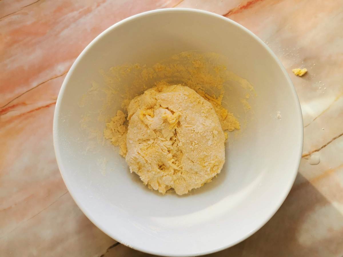 Rough dough ball inside white bowl.