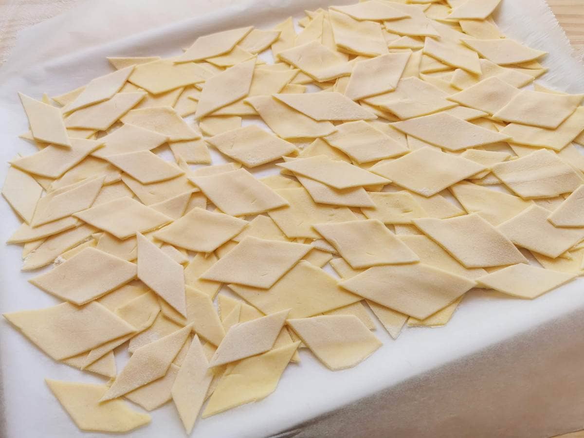 Ready homemade maltagliati on floured baking paper