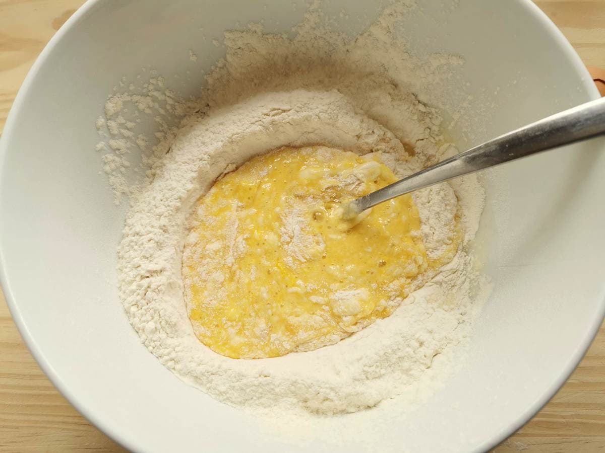 Flour and beaten eggs in white bowl.