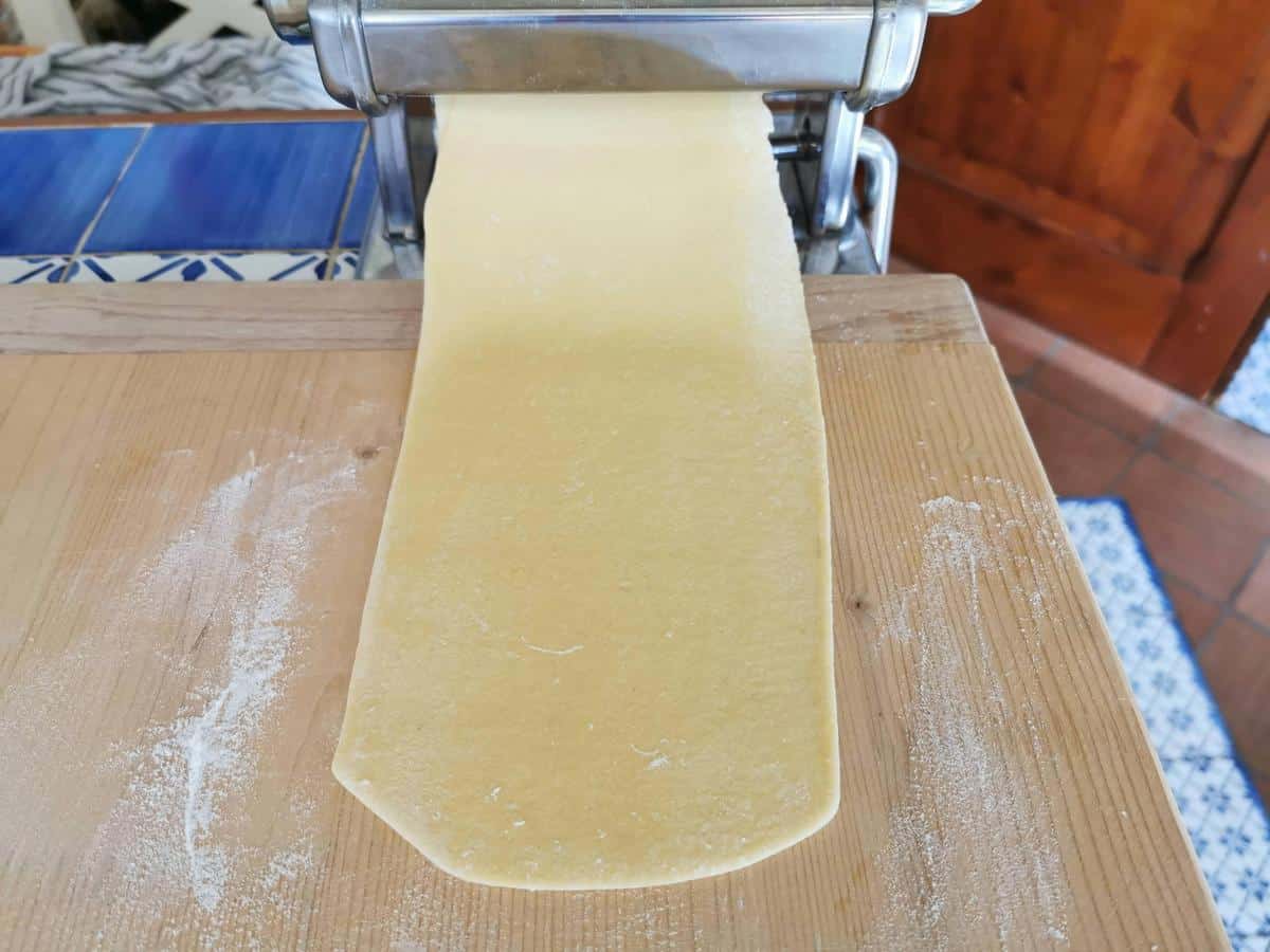 Ravioli dough sheet in pasta machine.