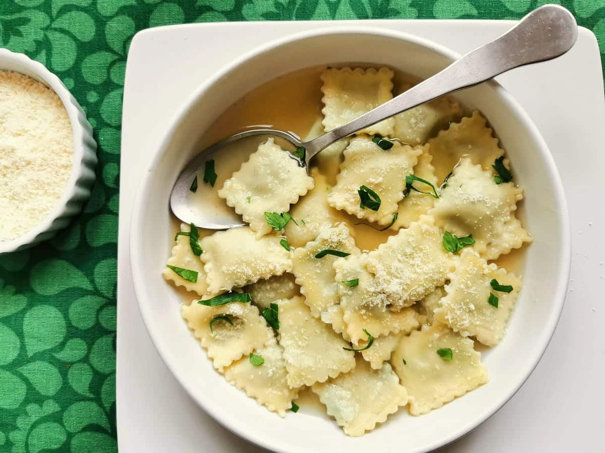 Italian homemade meat ravioli (agnolotti) in broth.