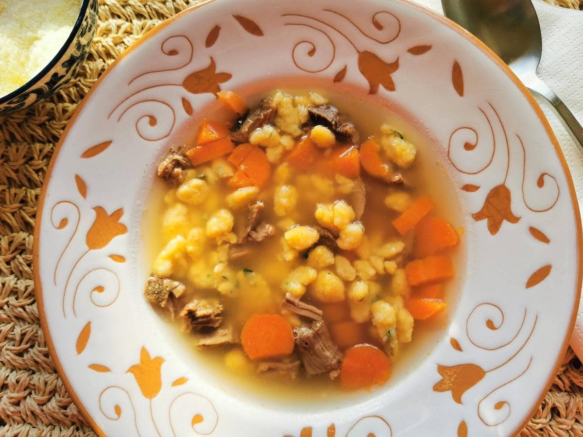Homemade pastina in broth with beef and carrots.