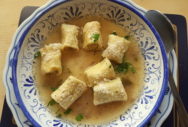 Homemade stuffed mezze maniche in broth 