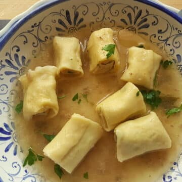 Homemade stuffed mezze maniche in broth