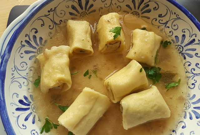 Homemade stuffed mezze maniche in broth