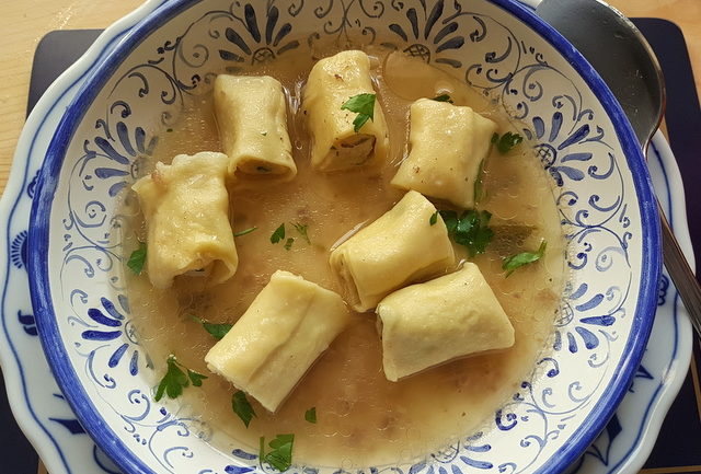 Homemade stuffed mezze maniche in broth 