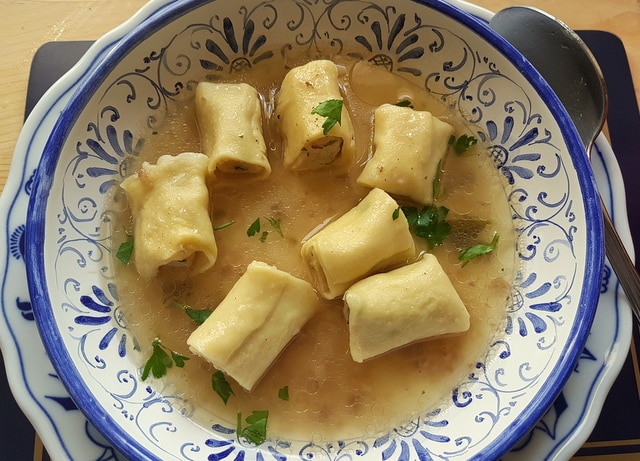 Homemade stuffed mezze maniche in broth