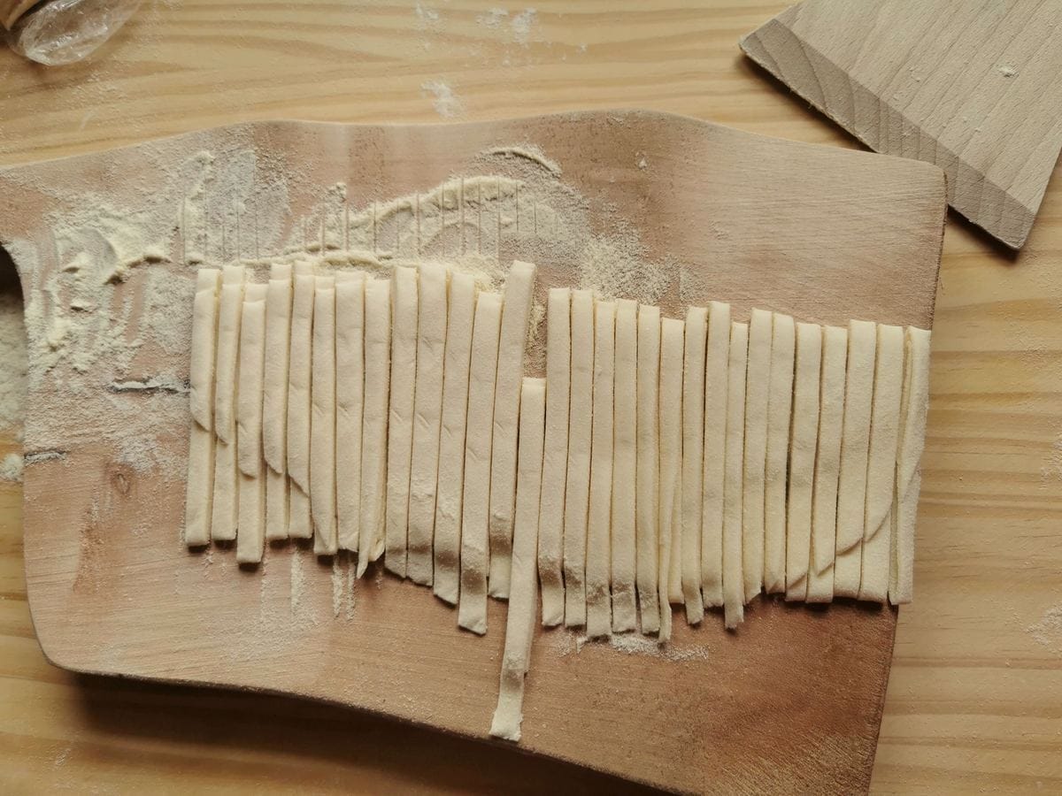 Rolled up strangozzi dough cut into ribbons.