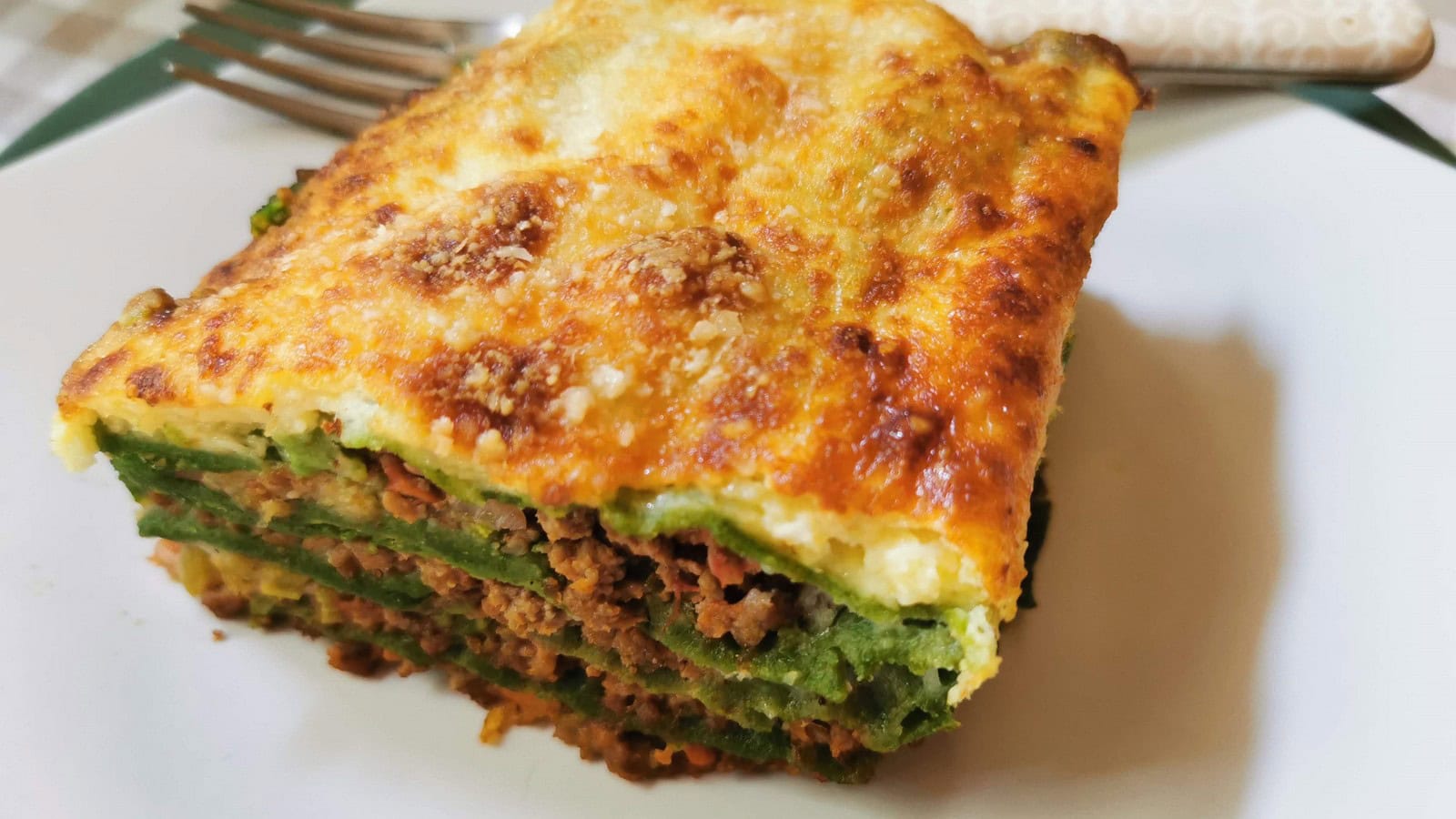 Lasagne al forno with bolognese and green pasta sheets.