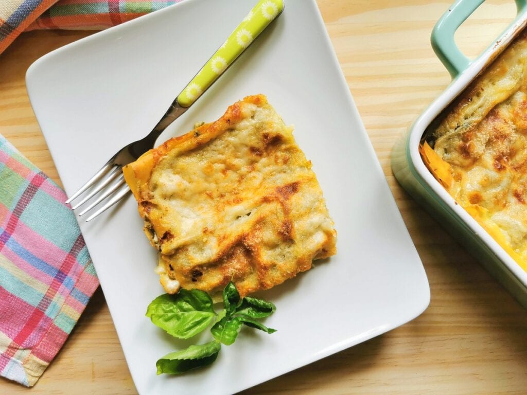 Italian basil pesto lasagna on a plate with a fork.