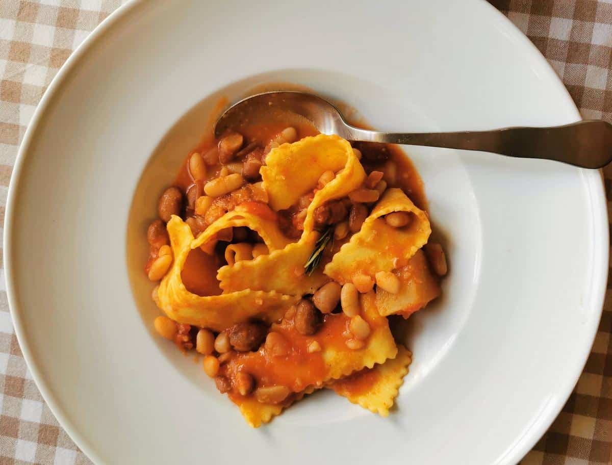 Italian pasta e fagioli in white bowl.
