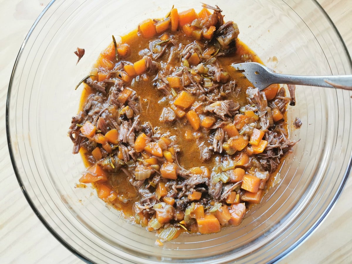 Ready Italian beef cheek ragu in glass bowl.