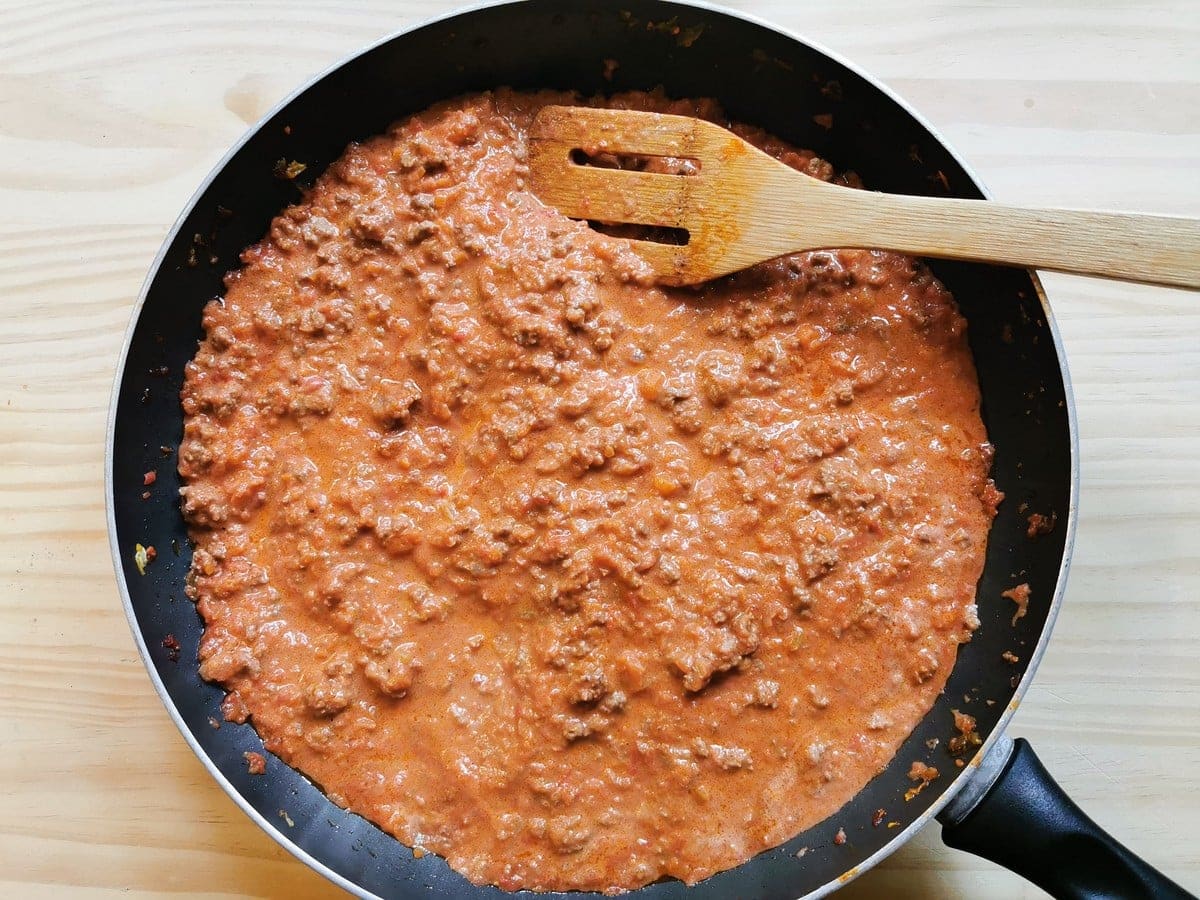 Ready creamy beef ragu in frying pan.