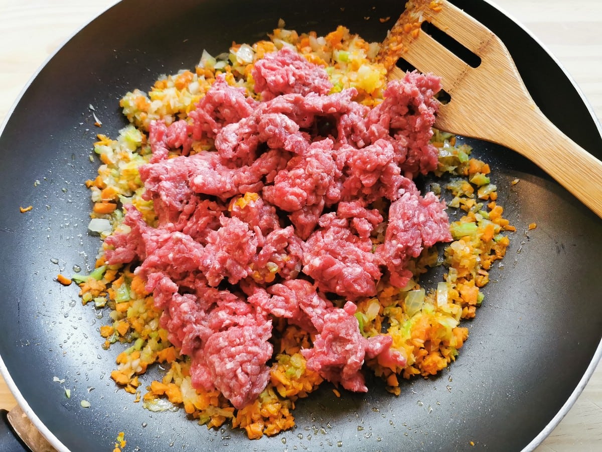 fresh ground beef added to pan with chopped onion, carrots and celery.