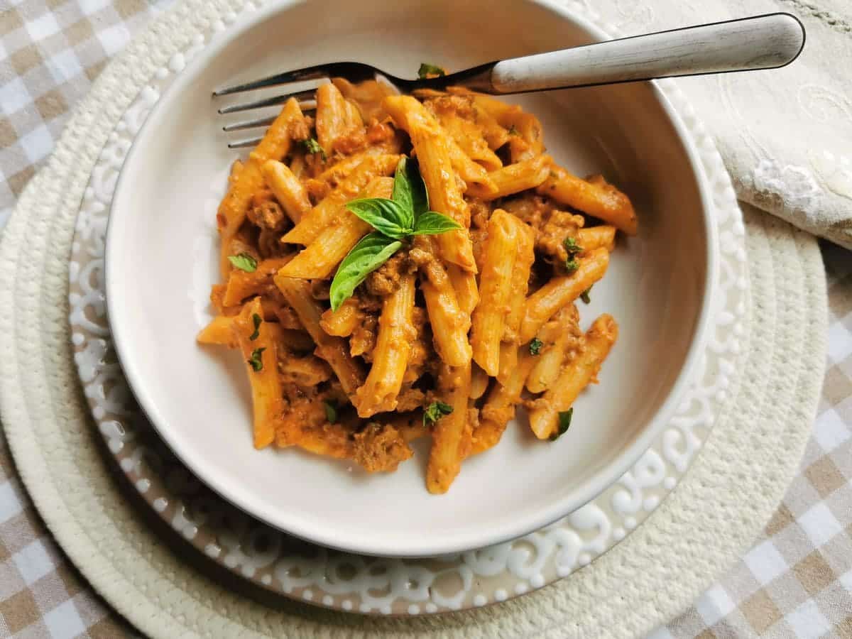 Italian creamy beef ragu with penne pasta in a bowl