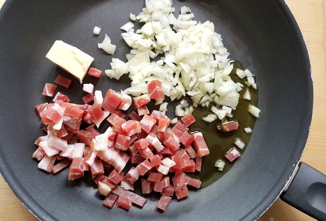 chopped onions and speck in skillet with olive oil and butter