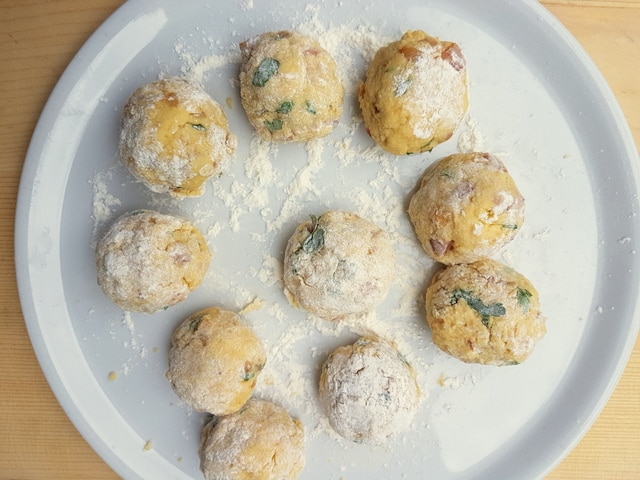 ready to cook Italian dumplings (canederli) on white plate