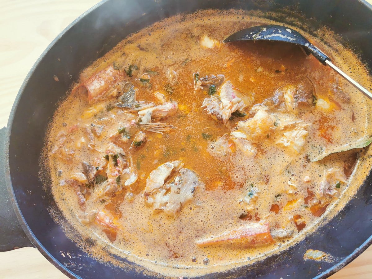 Fish soup cooking in Dutch oven.