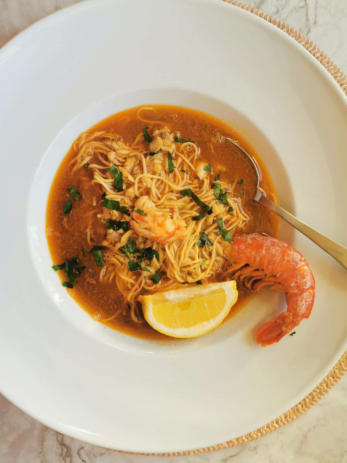 Italian fish soup with angel hair pasta and prawns.