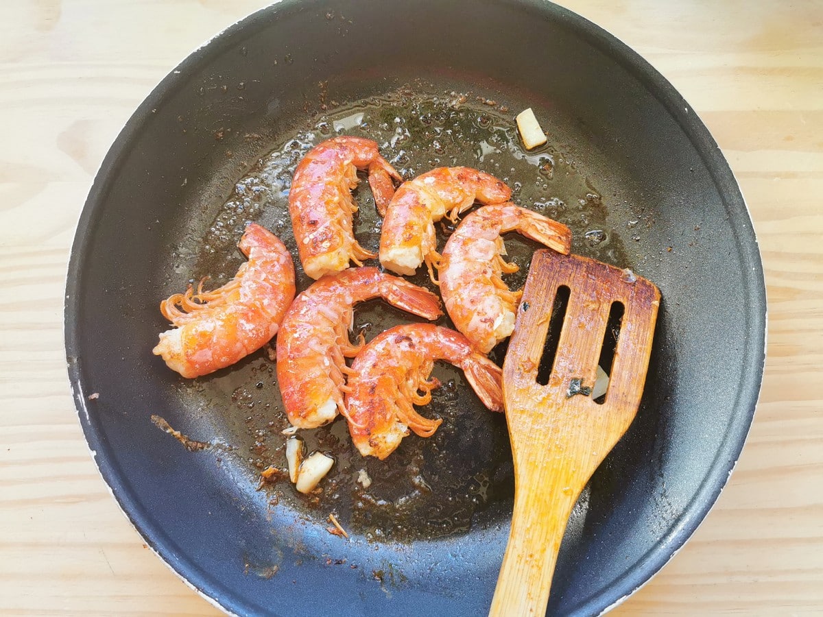 Sautéèd prawn tails in small frying pan with butter and garlic.