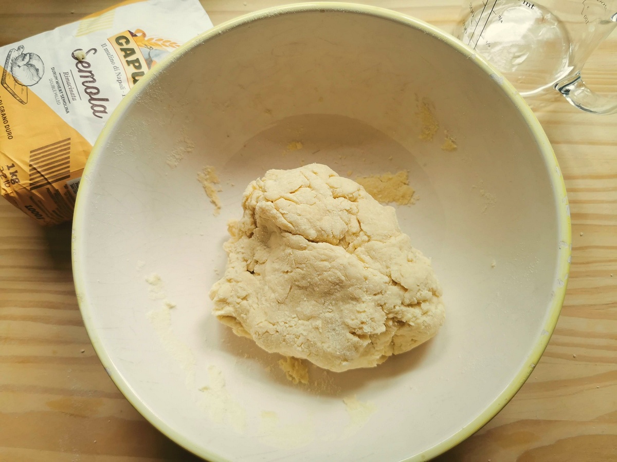 Ball of eggless pasta dough in large bowl.