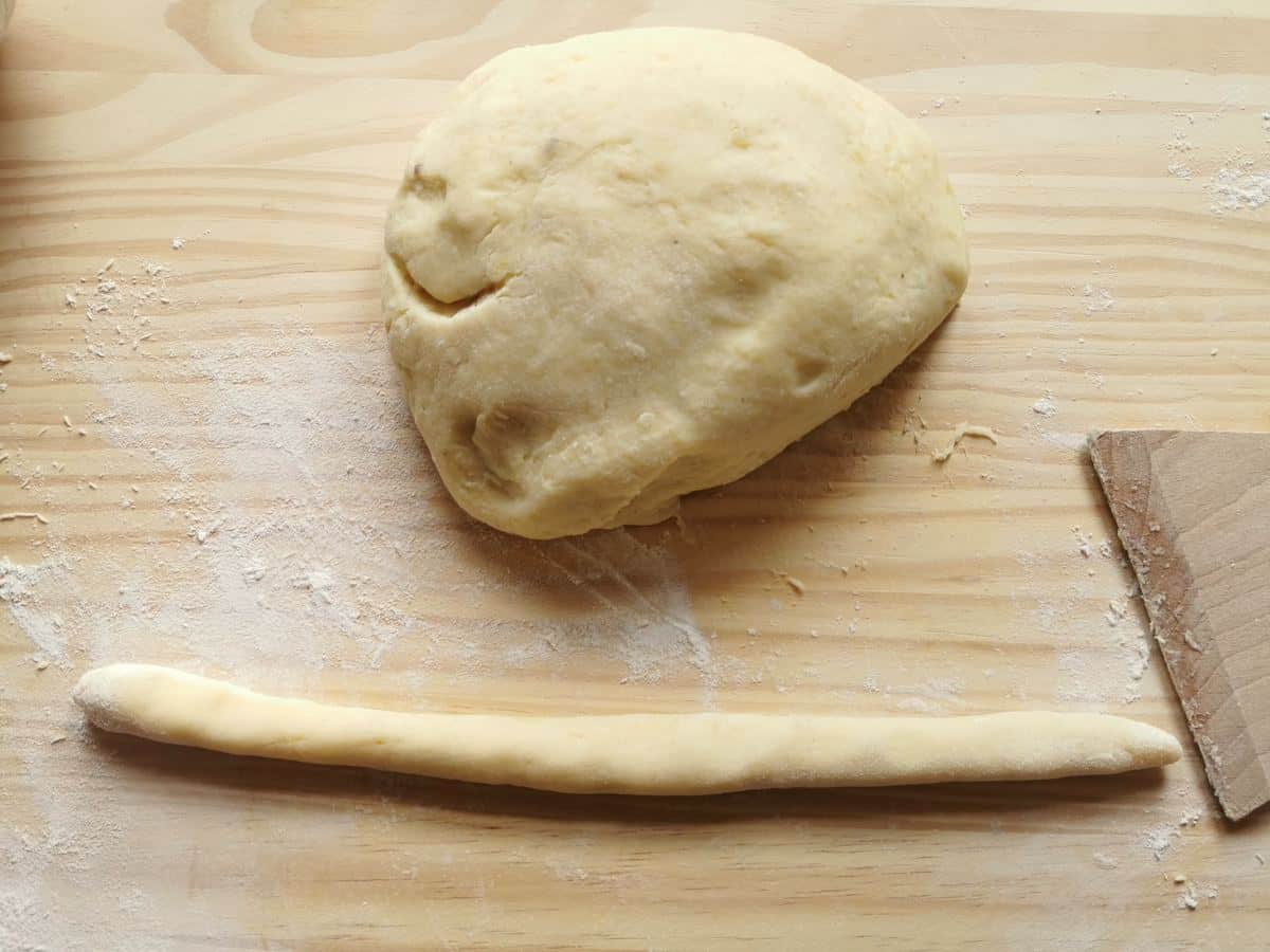 Ball of gnocchi dough and piece of the dough rolled out into a long rope.