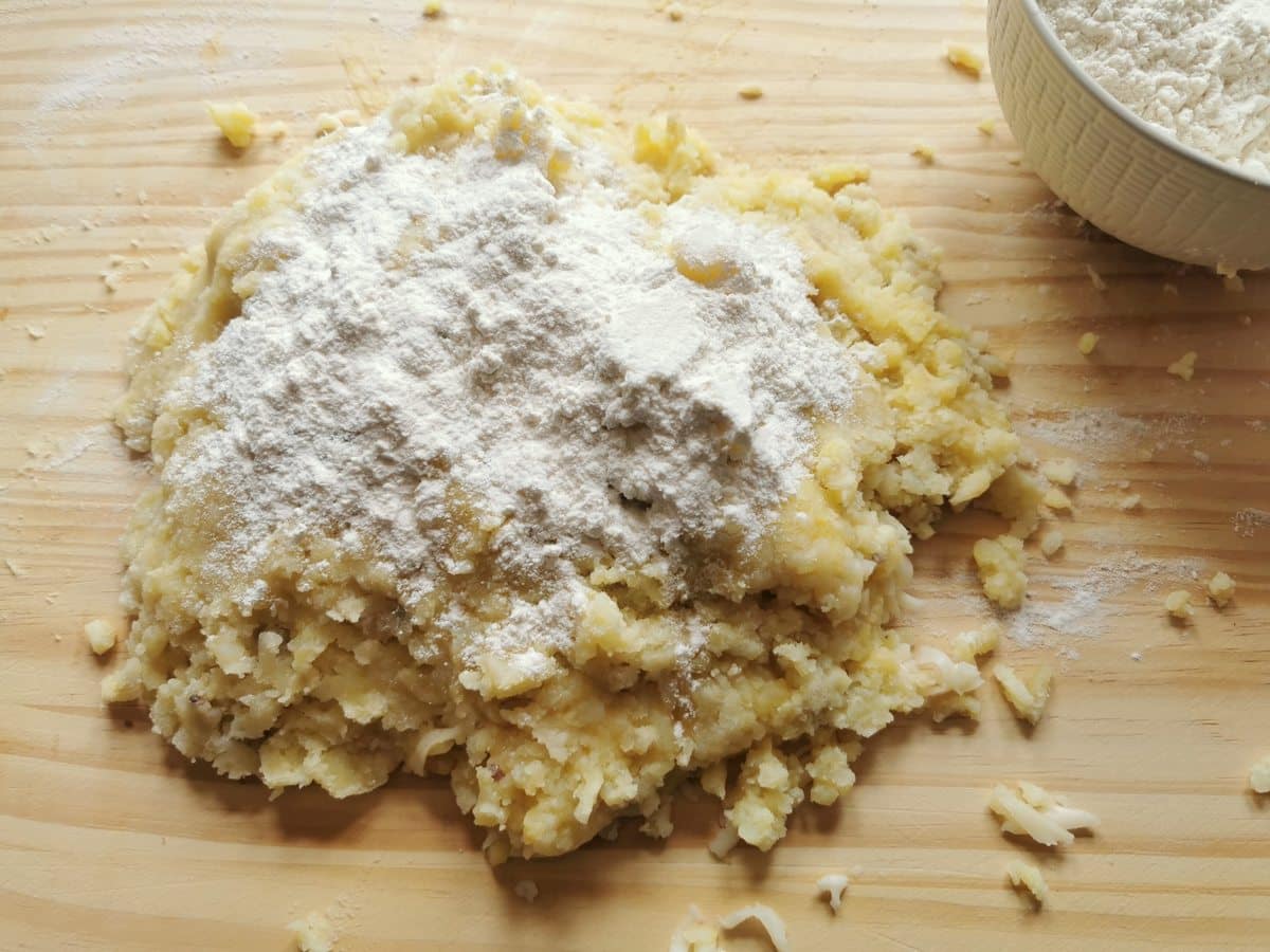 Potato, cheese and egg mixed together with flour on top.
