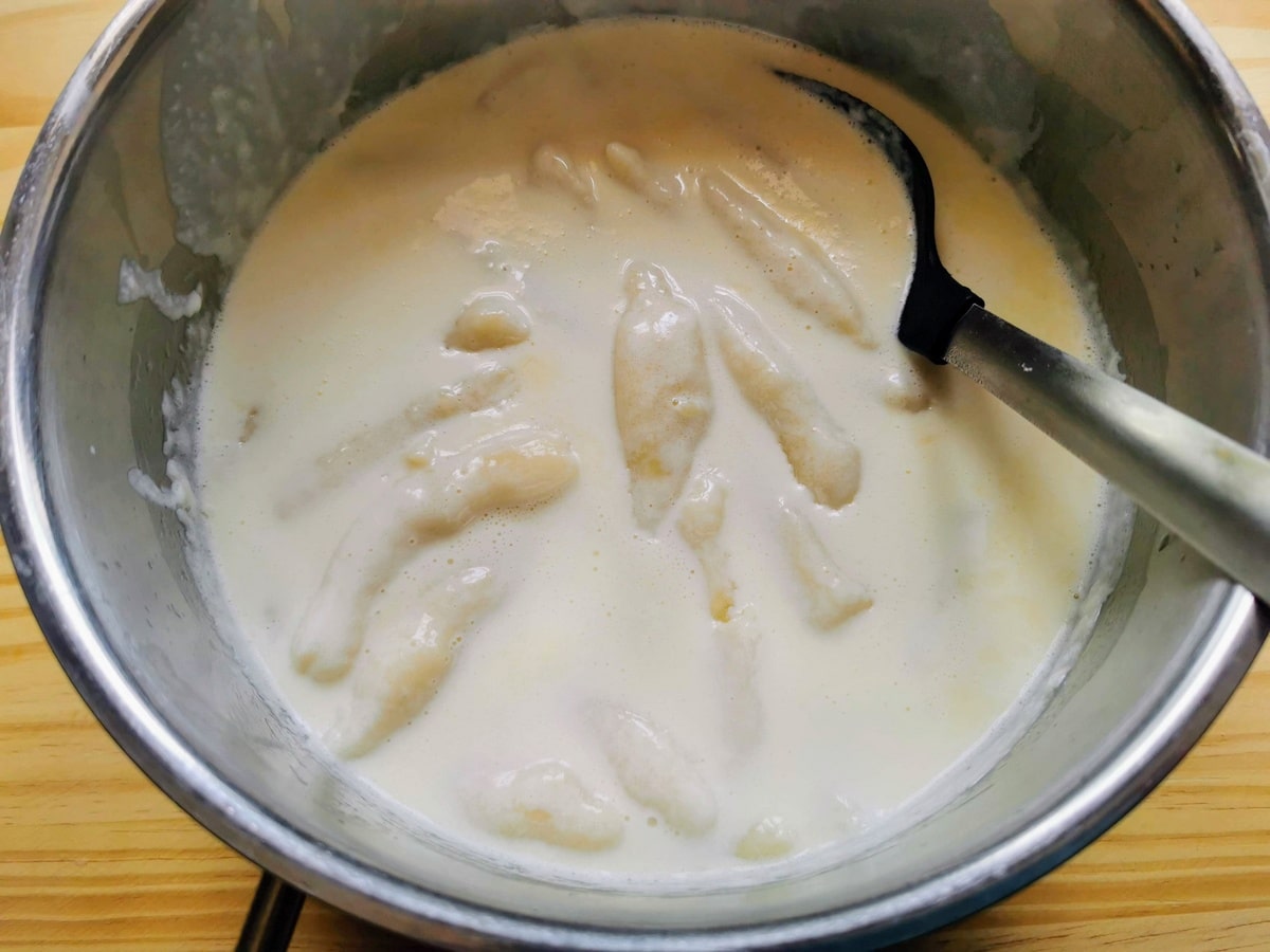 Italian potato gnocchi in deep pan with cheese sauce.