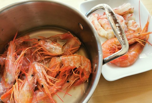 prawn heads and shells in saucepan with water