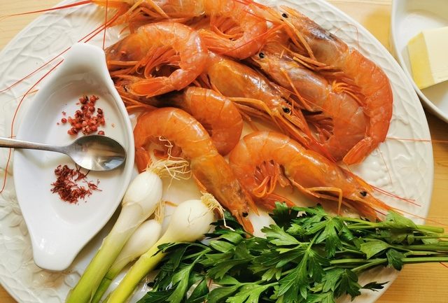 ingredients for prawn saffron linguine sauce on white plate