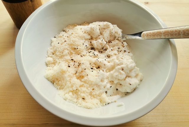 ricotta and grated parmigiano in white bowl