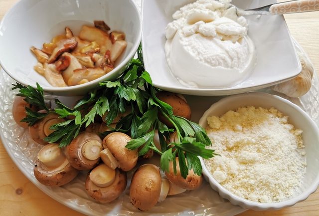 Ingredients for Italian ricotta mushroom lasagne al forno on white plate.