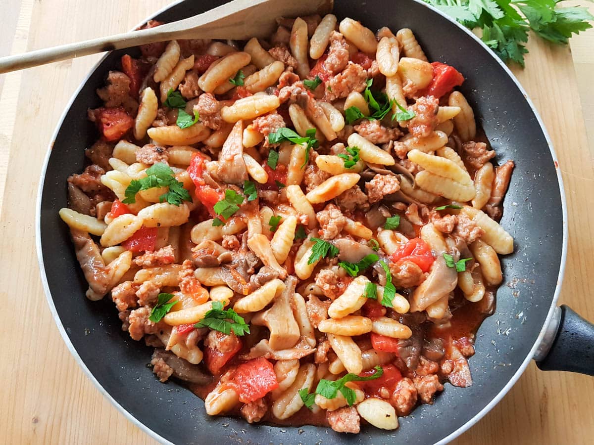 Cavatelli Pasta with oyster mushrooms and sausage in a skillet.