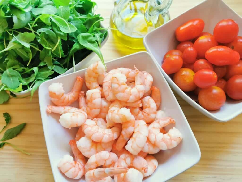 ingredients for cold spaghetti salad in white bowls