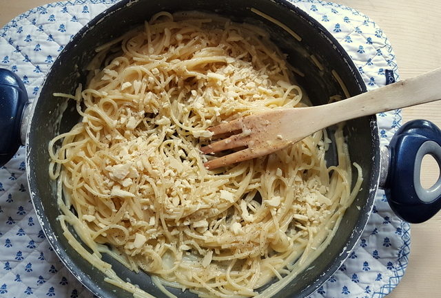 spaghetti and cheese in frying pan for lemon water spaghetti recipe