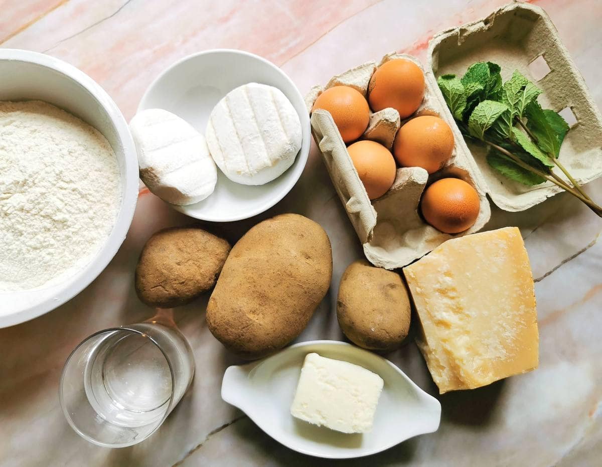 ingredients to make potato and mint ravioli on marble worktop