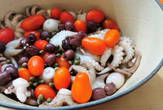 baby octopus, capers, olives and datterini tomatoes in Dutch oven