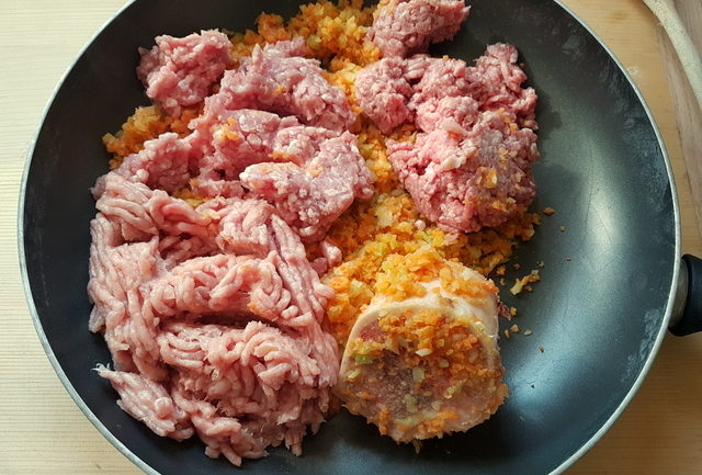ground beef, pork and chicken and beef marrow bone with chopped vegetables in frying pan